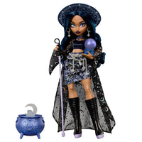 Doll with dark hair wearing celestial-themed outfit, holding a purple orb and staff, standing next to a blue cauldron.