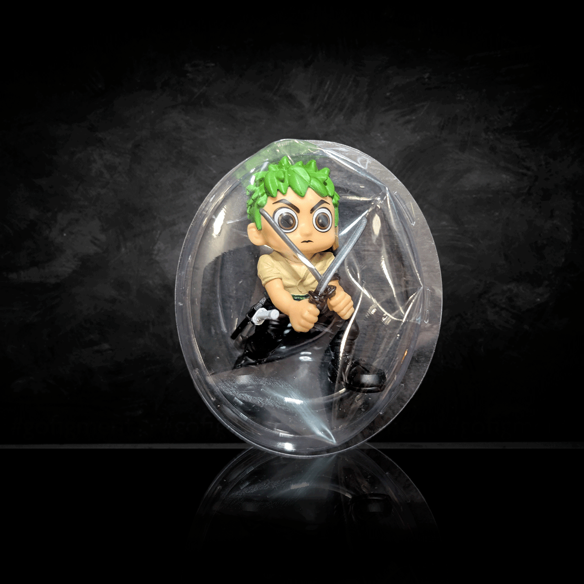 Go Figment One Piece mini figure Zoro with swords inside clear blind box packaging on black background