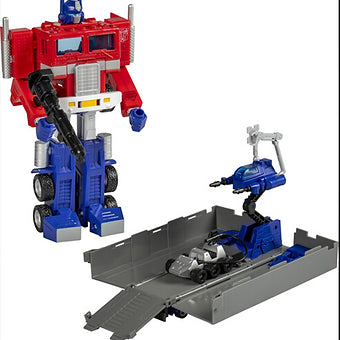 Hasbro Transformers G1 Optimus Prime action figure with trailer converted into battle station and accessories displayed