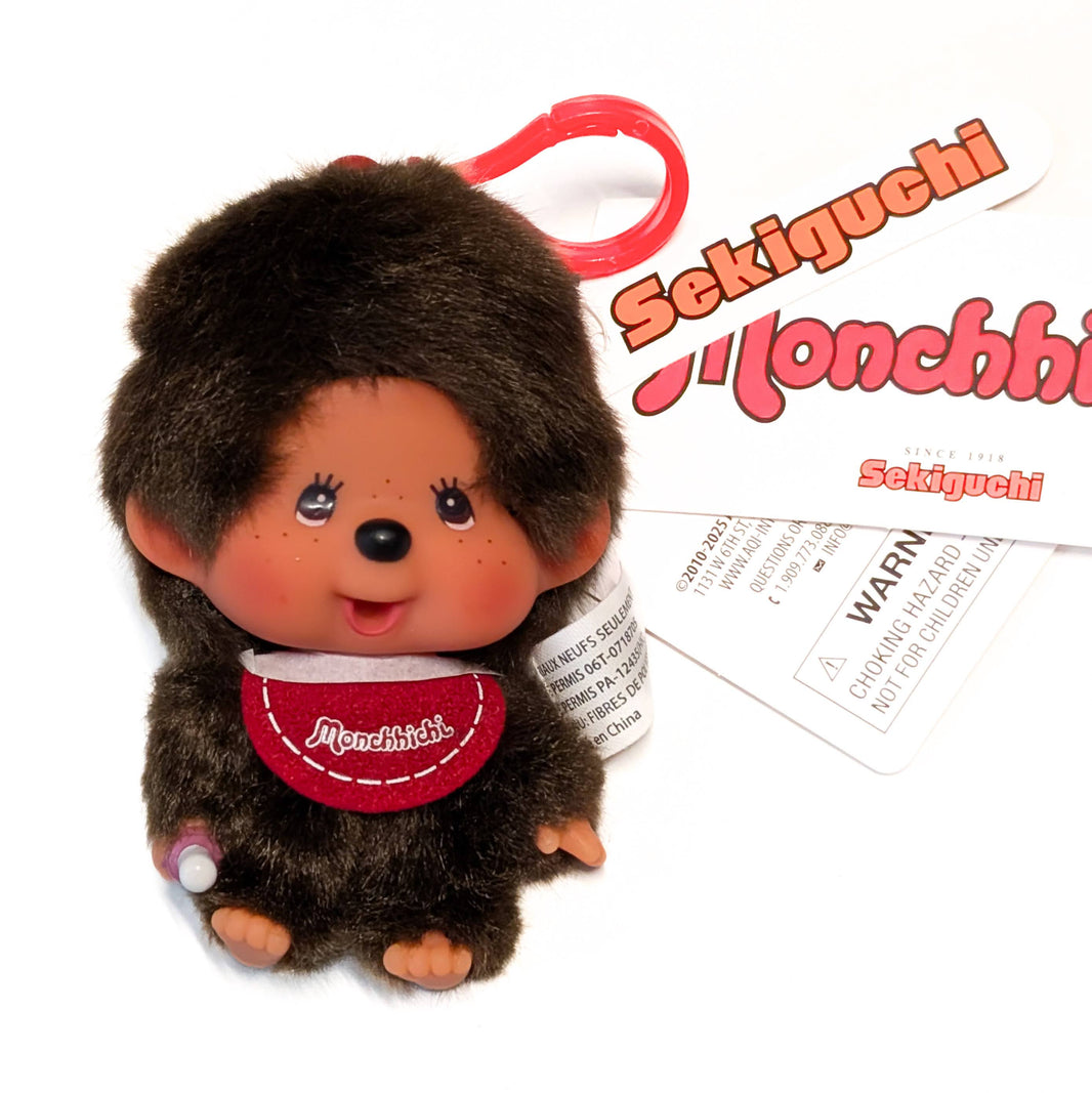Sekiguchi Monchhichi Boy Classic Big Head plush mascot clip with thumb-sucking pose and branded tags visible