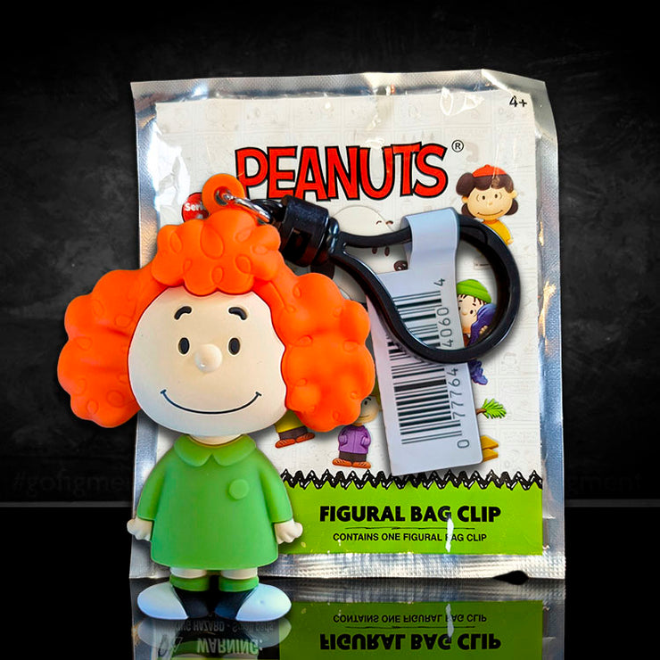 Monogram Peanuts Frieda figural bag clip with bright orange curly hair and green coat from Series 4 collection.