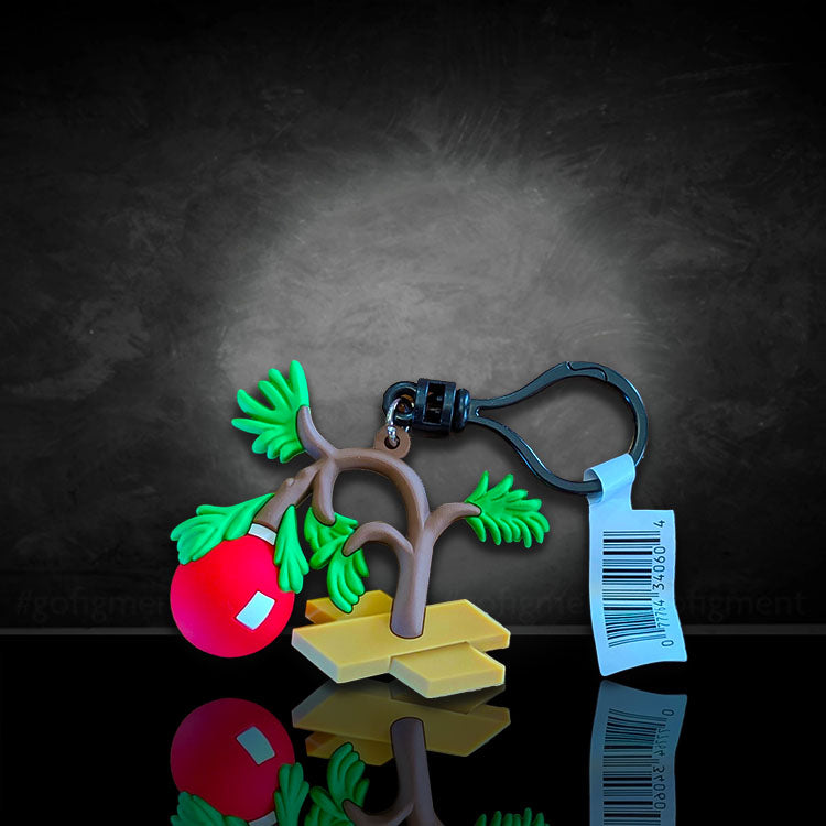 Monogram Charlie Brown Christmas Tree Peanuts Series 4 figural bag clip with keychain and tag against dark background