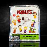 Monogram Peanuts Series 4 figural bag clip blind box featuring characters like Frieda and Snoopy in colorful packaging.