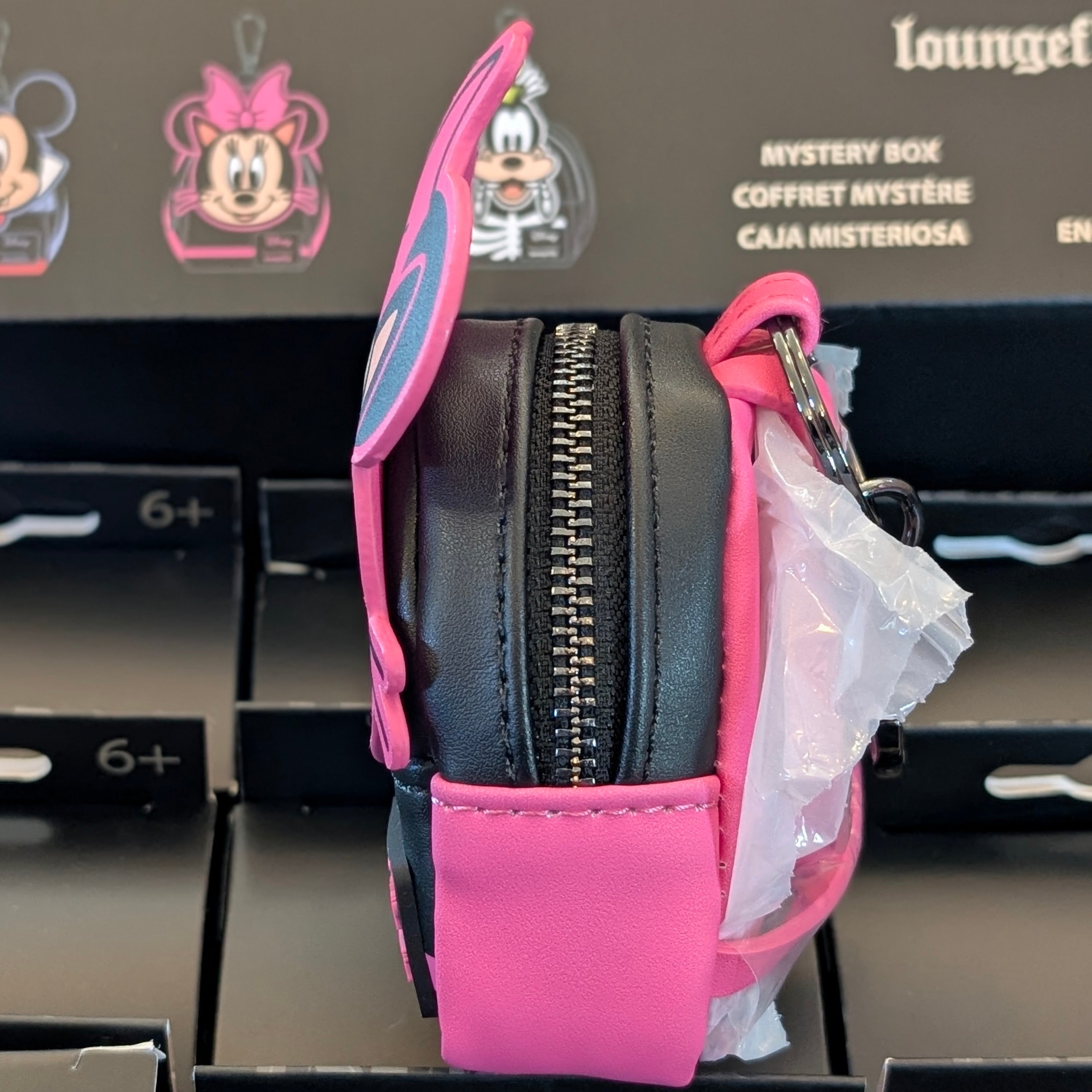 Side view of Loungefly mini backpack bag charm featuring Minnie Mouse dressed as a cat with pink accents and working zipper