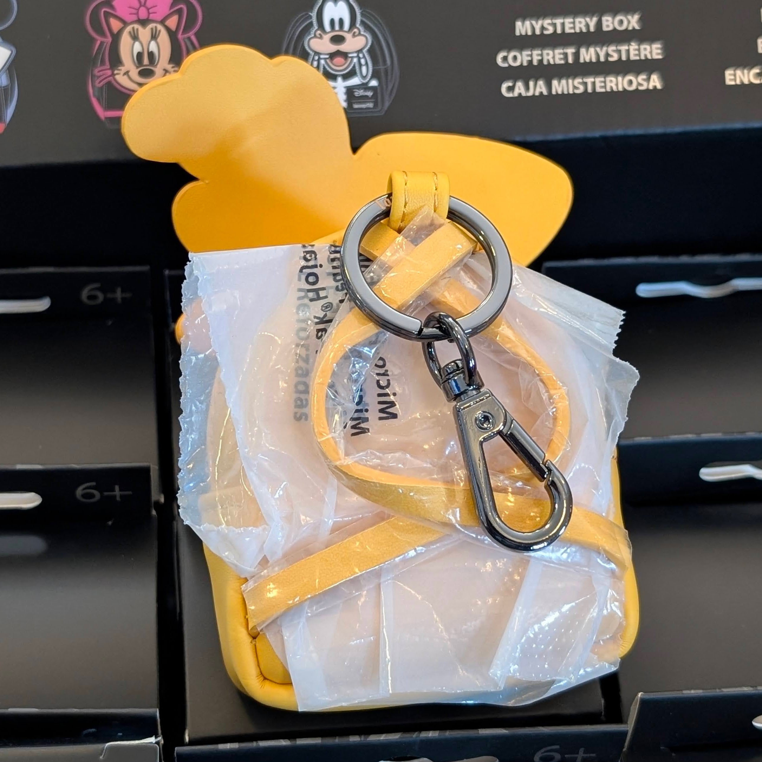 Loungefly Disney mini backpack bag charm featuring yellow Pluto ears keychain clip accessory.