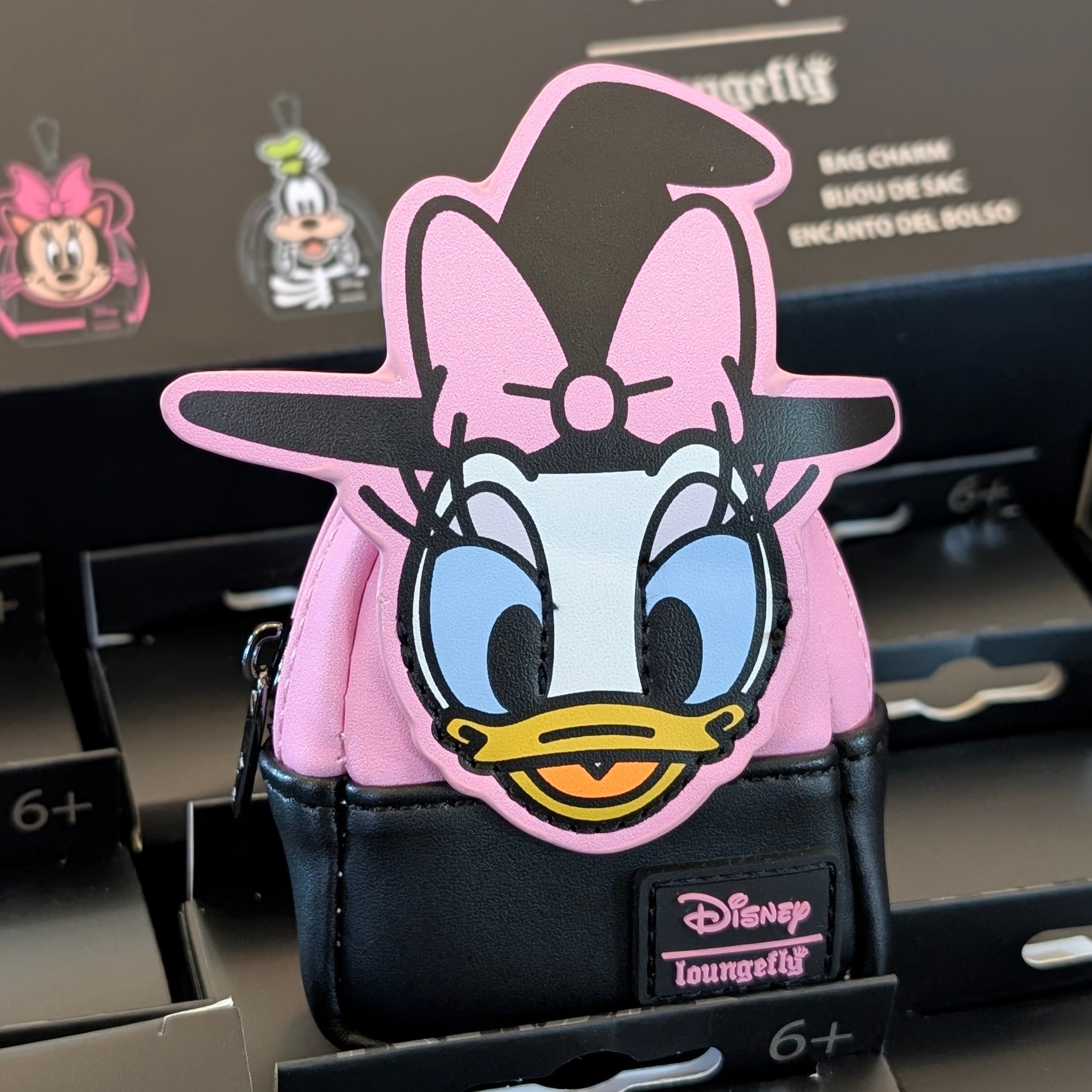 Disney Loungefly Witch Daisy Duck mini backpack charm in pink and black with a zipper and witch hat detail