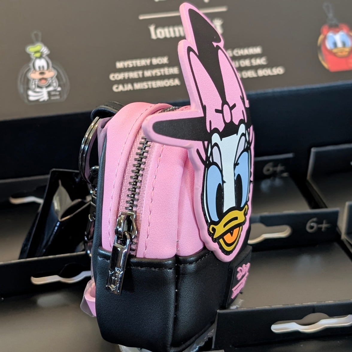 Loungefly Witch Daisy Duck mini backpack bag charm with pink and black design and functioning zipper detail.