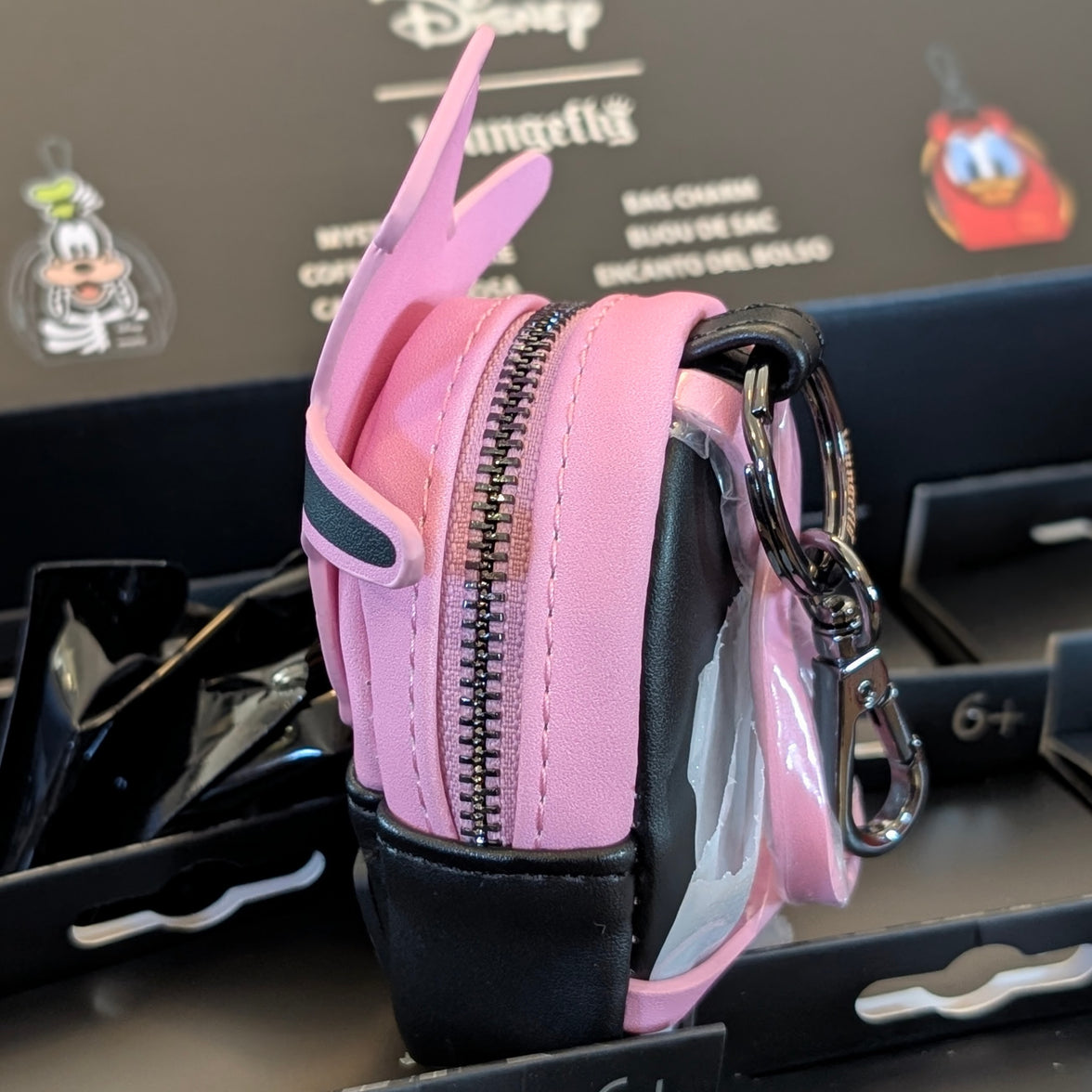Side view of pink and black Loungefly mini backpack bag charm with zipper and keychain clip