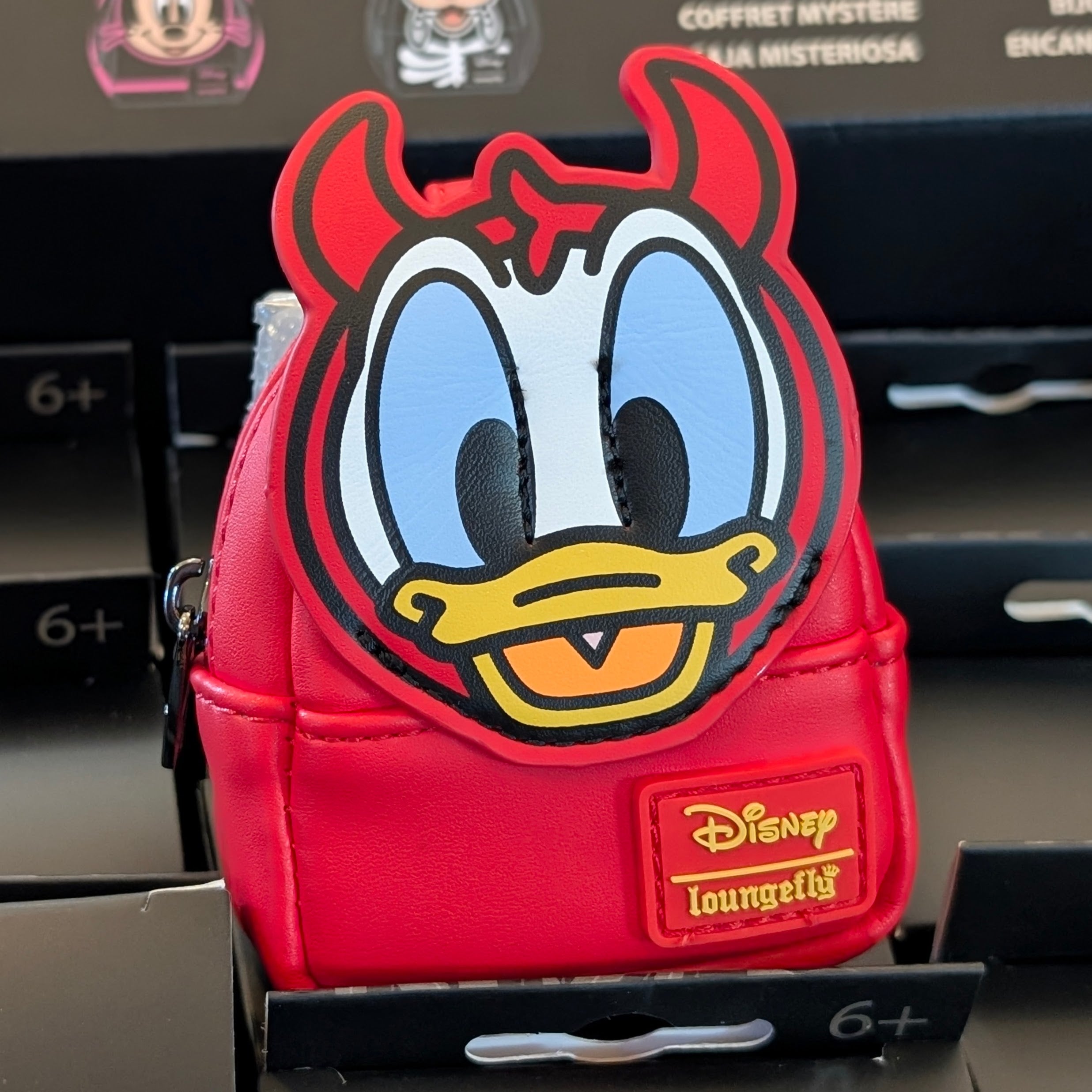 Red Loungefly mini backpack charm featuring Donald Duck with devil horns and Disney branding on front pocket.