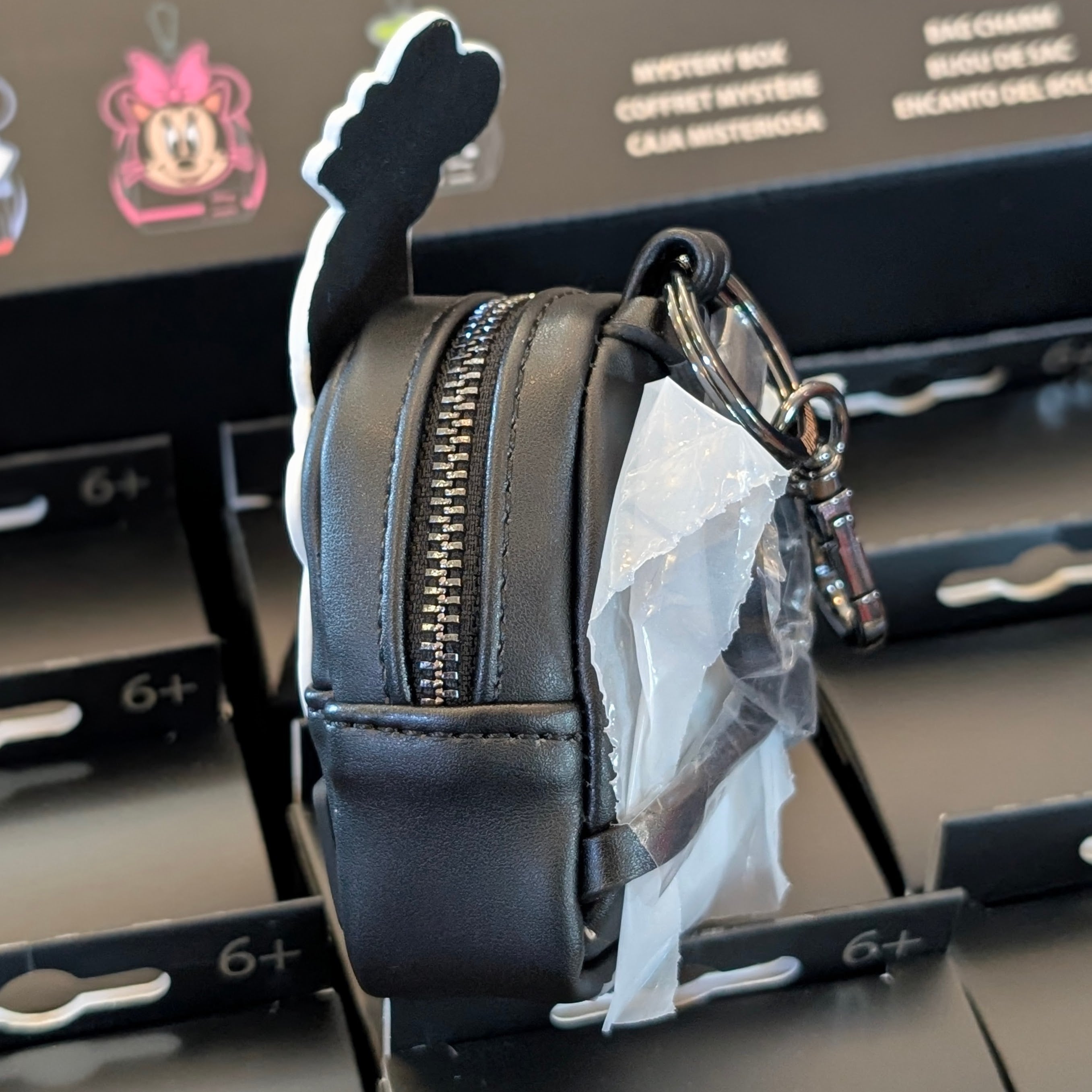 Side view of black Loungefly mini backpack bag charm with Skeleton Goofy design and zipper detail