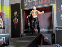 Action figure wrestler with face paint and tattoos holding a championship belt on a stage ramp with Lucha Libre branding.