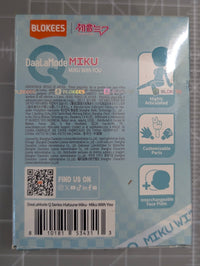 The back of a Blokees DaBaLaMode MIKU mini wrist filter box, showing product information, icons, and a barcode, placed on a gray cutting mat.