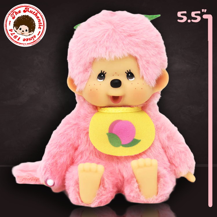 Sekiguchi Monchhichi plush in peach pink with fruit bib, plastic face, hands, and feet, 5.5 inches tall collectible doll