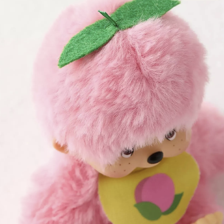 Sekiguchi Monchhichi 5" plush in peach pink with soft fur and green leaf detail on head.