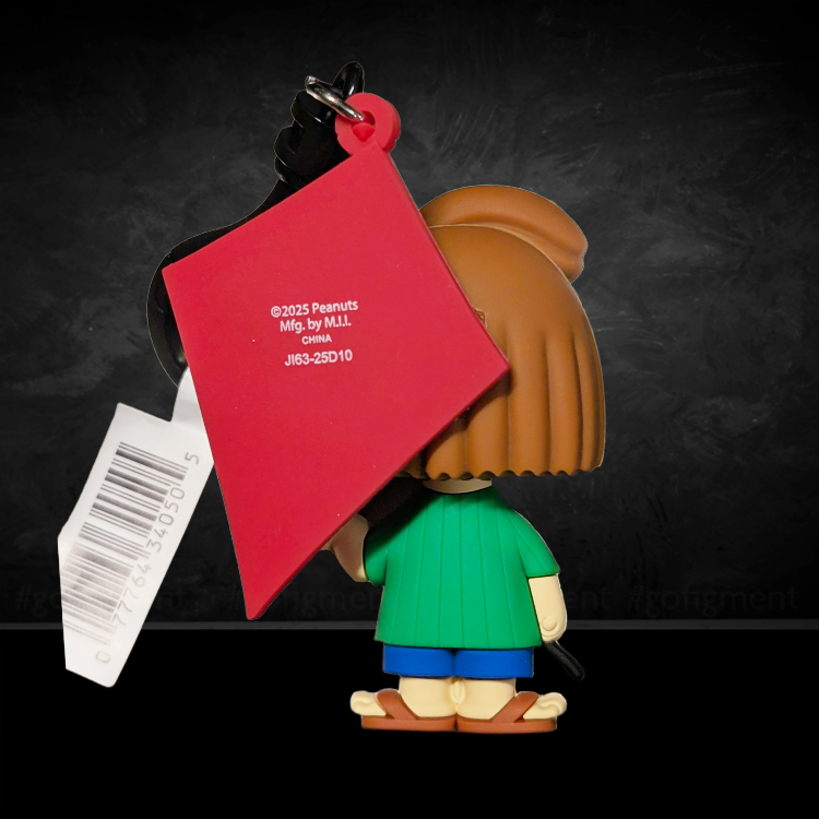 Back view of Monogram Peanuts Peppermint Patty 3D foam bag clip holding a red kite with barcode tag attached