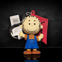 3D foam Pig-Pen bag clip wearing blue overalls and brown shirt holding a red kite by Monogram