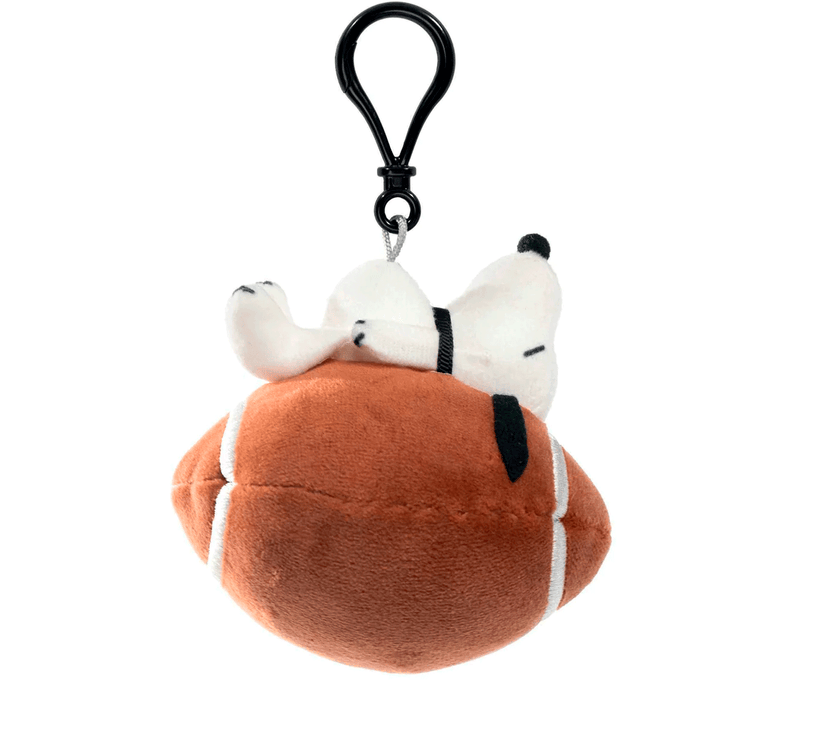 Peanuts Snoopy plush keychain bag clip resting on a football by Go Figment with black clip attachment