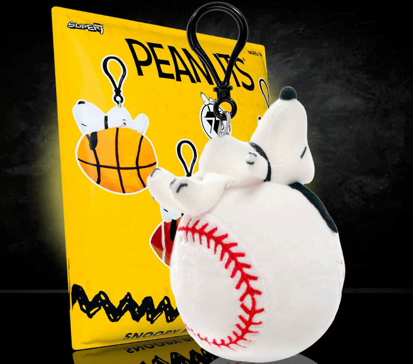 Go Figment Peanuts plush keychain featuring Snoopy on a baseball with black clip attached on yellow backing card