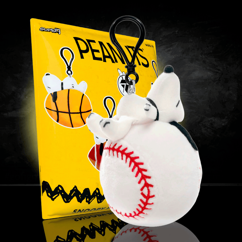 Go Figment Peanuts plush keychain featuring Snoopy on a baseball with black clip attached on yellow backing card