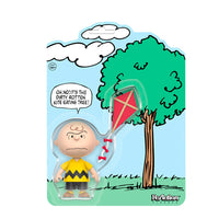 Super7 Charlie Brown ReAction Figure with kite and Kite-Eating Tree comic panel packaging display.