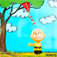 Super7 Charlie Brown and Kite-Eating Tree ReAction Figure scene capturing iconic kite struggle from Peanuts comics.