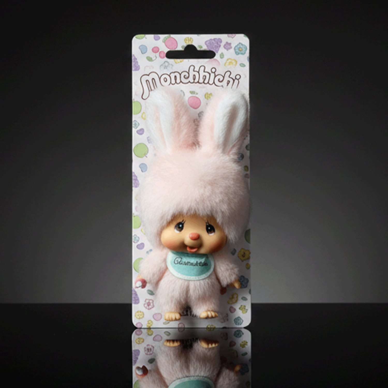 Sekiguchi 4-inch Monchhichi plush keychain in soft pink bunny outfit with blue bib labeled Chimutan on colorful backing card