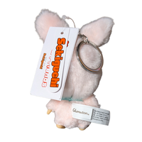 Pink Monchhichi plush keychain with oversized ears and attached tags