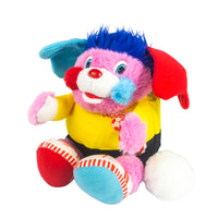 Colorful pink plush dog with blue hair, red ears, yellow shirt, and red and blue shoes