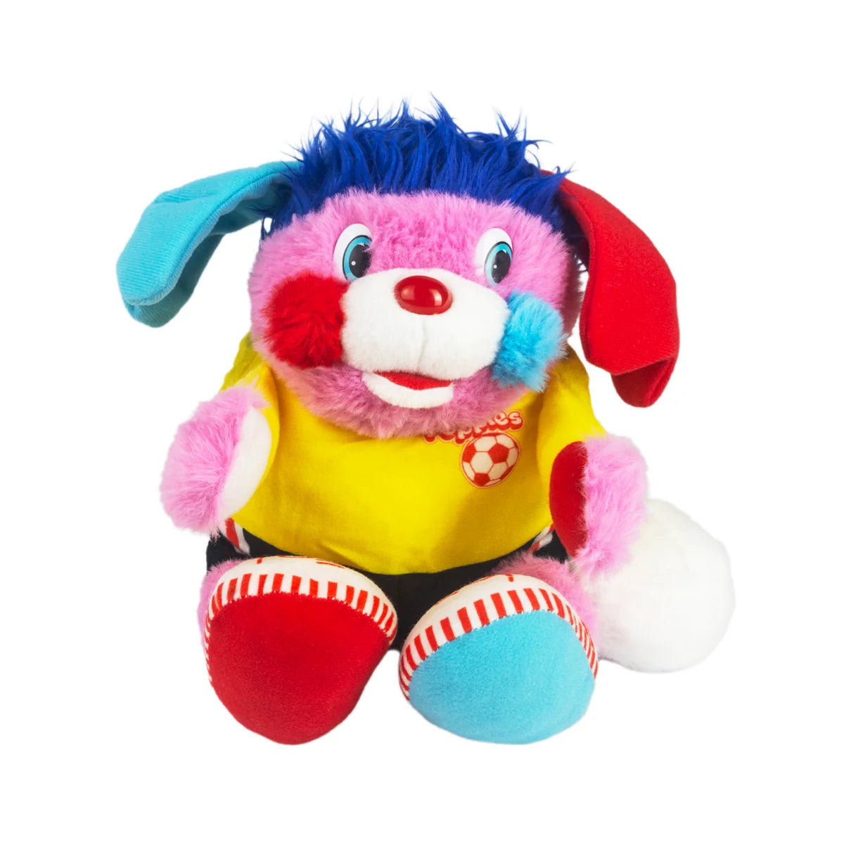 Colorful plush dog with pink fur, blue hair, mismatched ears, yellow shirt, and soccer ball detail