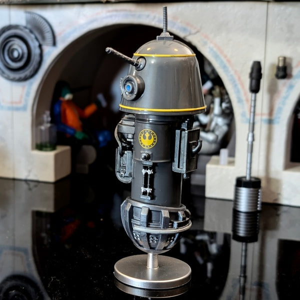 Kenner R1 Droid action figure from Star Wars Droid Factory with matte black finish and yellow accents on hover stand