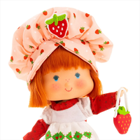 Complete Strawberry Shortcake doll by Loyal Subjects wearing a strawberry hat and holding a strawberry purse