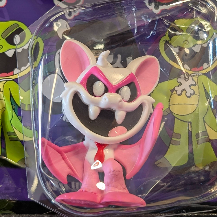 Go Figment Nightmare Critters Series 4 pink bat-like figure with red tie inside clear packaging on purple background