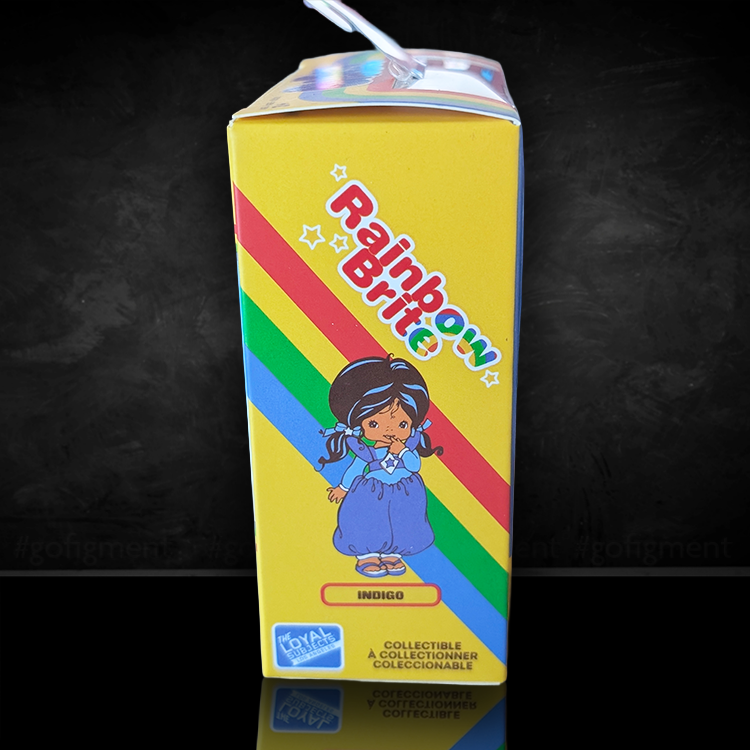 Rainbow Brite Indigo collectible figure box with colorful stripes and character artwork on yellow background