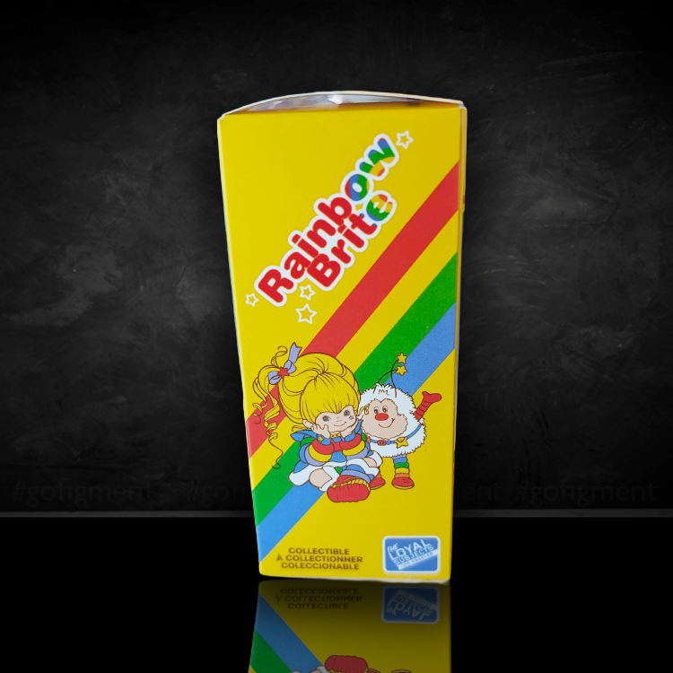 Bright yellow Rainbow Brite box with colorful rainbow stripes and playful Rainbow Brite characters illustration