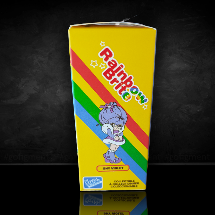 Yellow box packaging of Shy Violet collectible figure from Rainbow Brite with rainbow stripes and character illustration on front