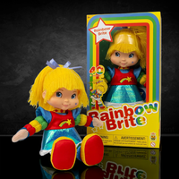Rainbow Brite plush doll with bright yellow hair and colorful outfit sitting next to its original packaging box.