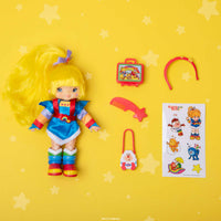Rainbow Brite 5.5 inch fashion doll with accessories and sticker sheet by Loyal Subjects on yellow star background