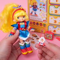 Rainbow Brite 5.5 inch fashion doll by Loyal Subjects with colorful outfit and accessories in hand held view