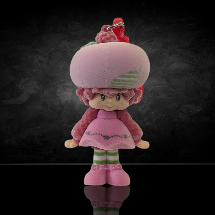 UCC World of Strawberry Shortcake soft flocked mini figure clip wearing pink outfit and striped leggings front view