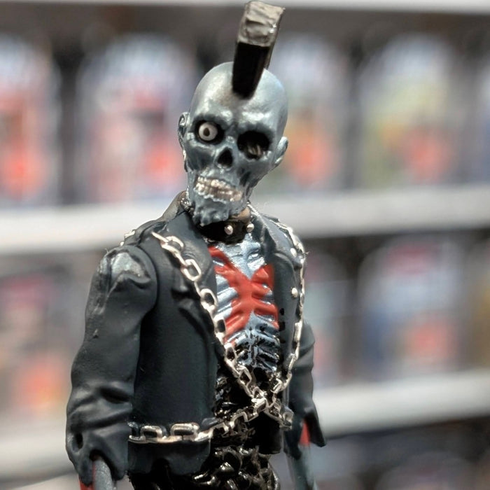 Super7 metallic blue graffiti male zombie figure with mohawk, exposed red and black skeletal chest, wearing black jacket and chains