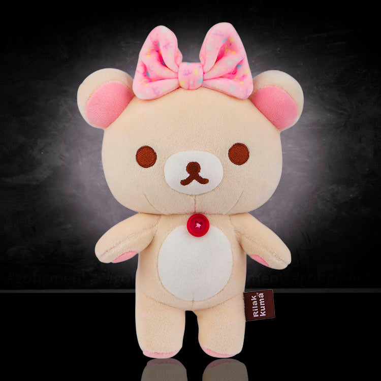 Korilakkuma plush mascot bear with pink bow by San-X, soft and squishy mochi design, 8 inches tall.