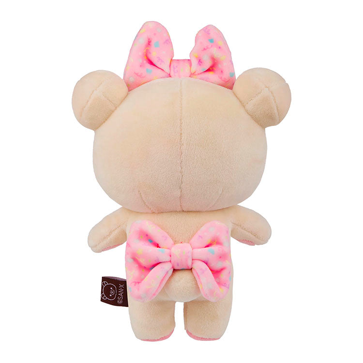 Korilakkuma mochi plush mascot bear from San-X with pink patterned bows shown from the back on white background