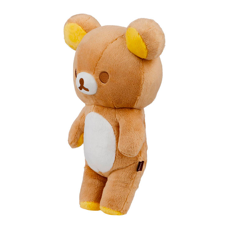 San-X Rilakkuma plush in standing pose with yellow accents and soft brown fur, cozy and adorable collectible toy
