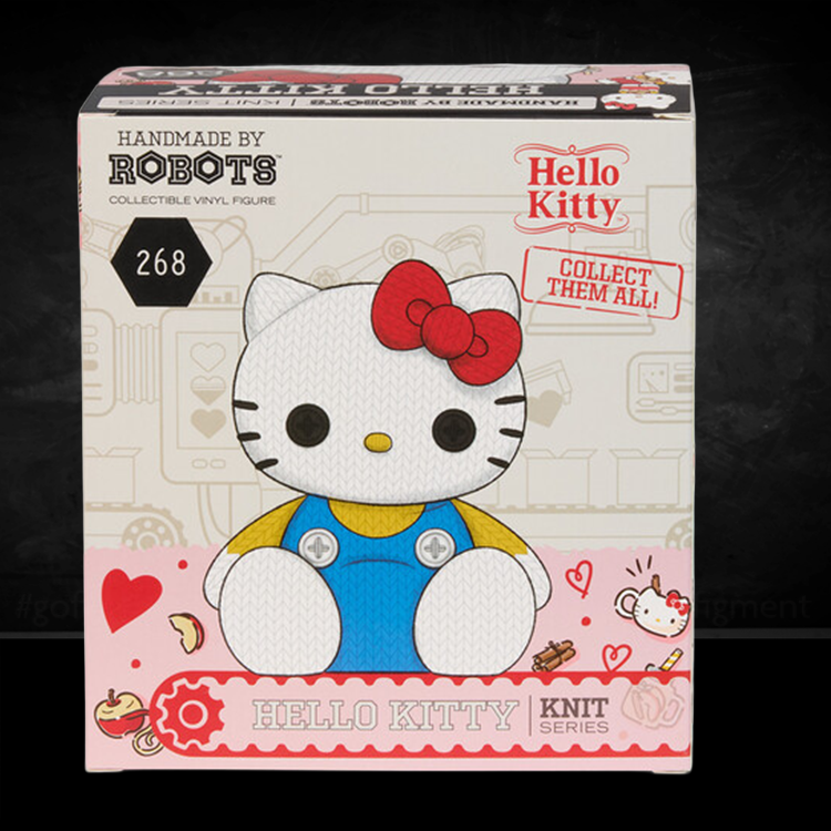 Handmade by Robots Hello Kitty collectible vinyl figure in knit-inspired design with red bow and blue overalls packaging.