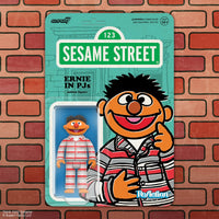Collectible Ernie figure dressed in red and white striped pajamas on retro green Sesame Street card backing.