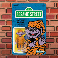 Purple vampire toy wearing orange pajamas with black bat patterns and matching nightcap on blue Sesame Street card backing.