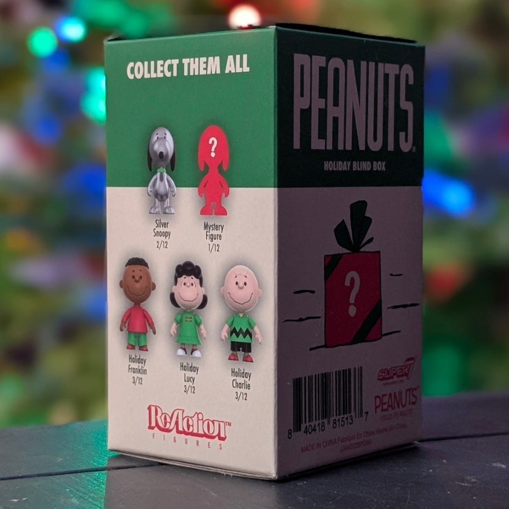 Peanuts Holiday Blind Box by Super7 showing figures including Franklin, Lucy, Charlie Brown, Silver Snoopy, and mystery figure silhouette