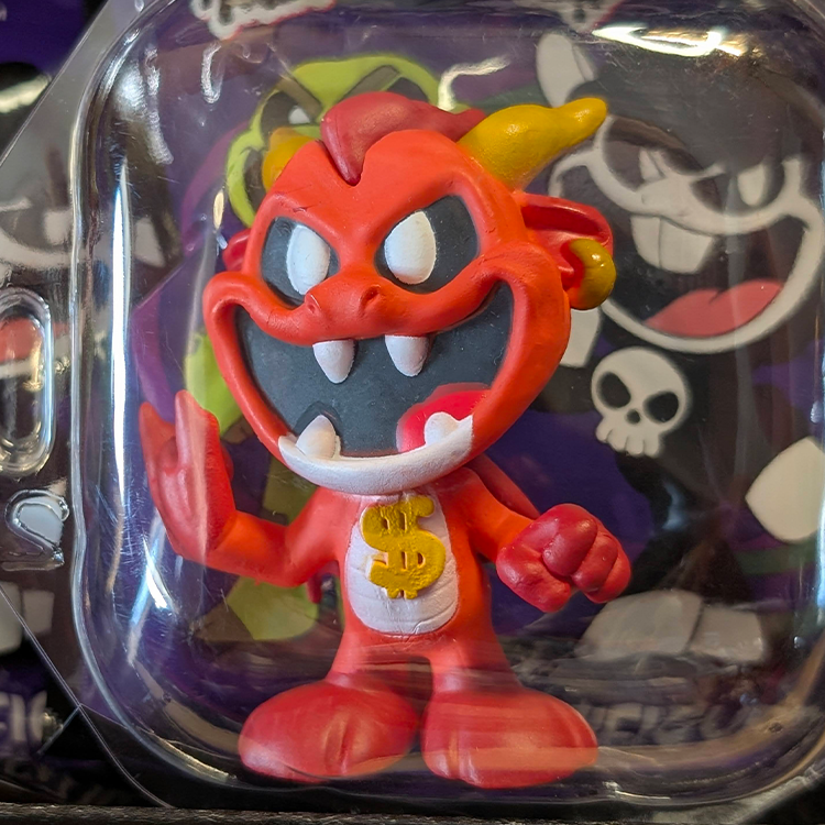 Go Figment Nightmare Critters Series 4 red devil figure with yellow horns and gold dollar sign on chest in clear packaging