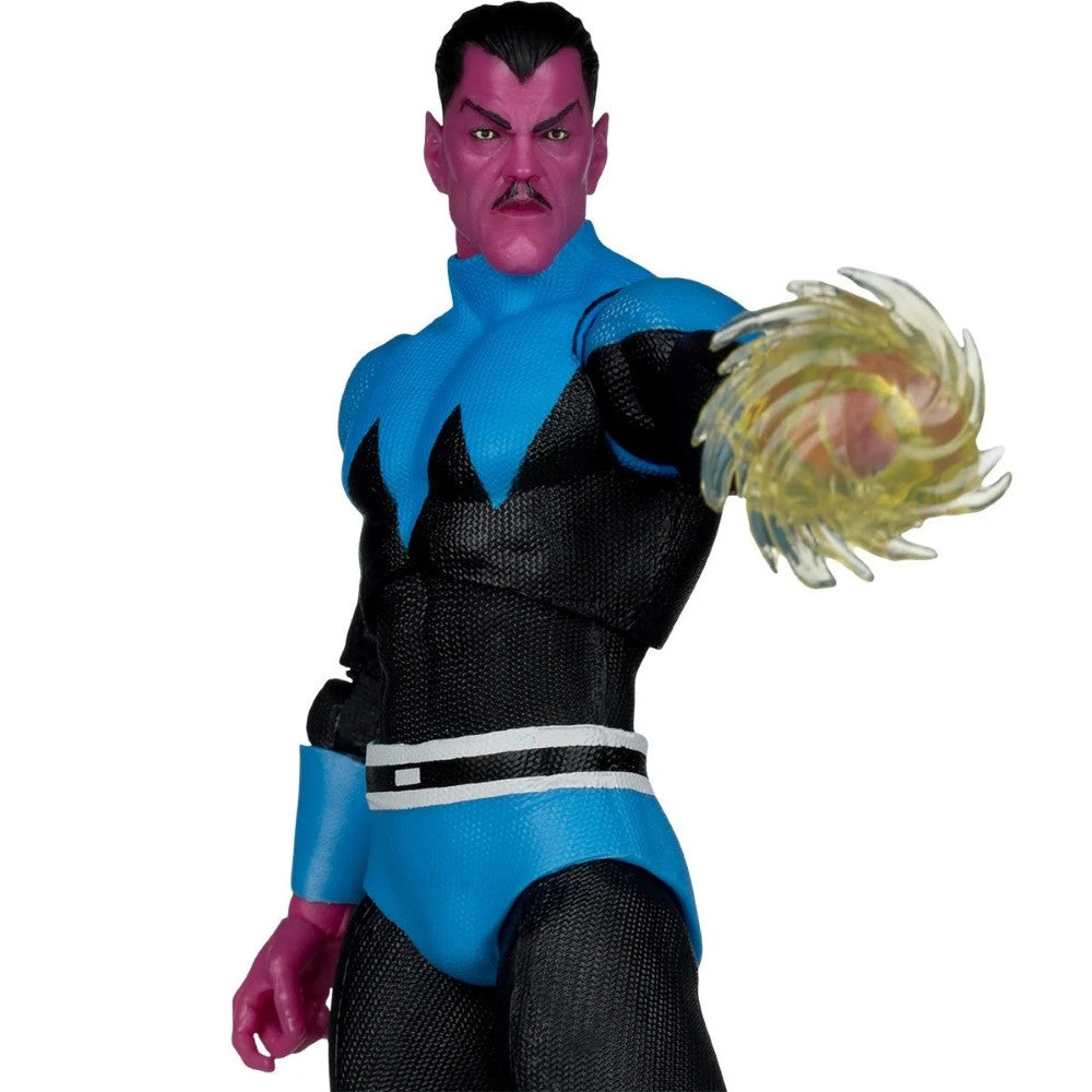 A collectible action figure of a superhero character with purple skin, wearing a blue and black textured costume, with one arm extended holding a translucent yellow energy blast effect, set against a plain white background.