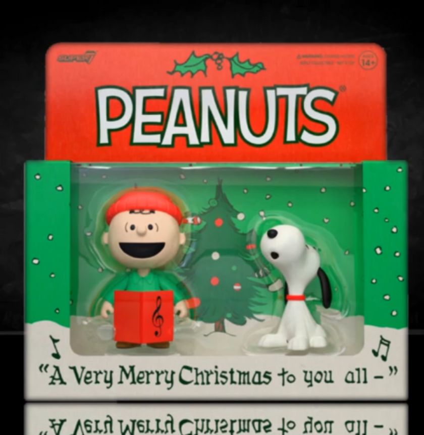 Peanuts Christmas-themed figurine set in packaging with 'Peanuts' branding.